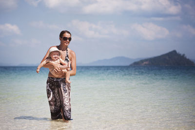 Mother with baby on beach, thailand