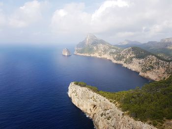 Scenic view of sea and mountains against sky