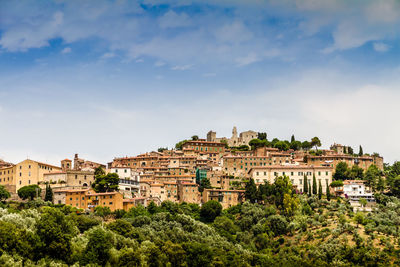 Buildings in town against sky