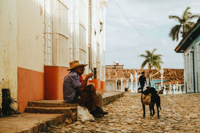 Man and dog sitting outdoors