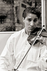 Portrait of young man playing violin