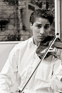 Portrait of young man sitting outdoors