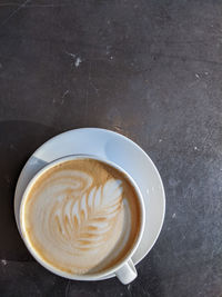 High angle view of cappuccino on table