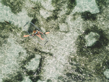 Aerial view of woman kayaking in sea