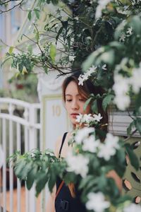 Woman standing by blooming flowers