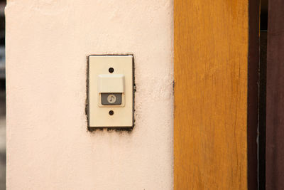 Close-up of telephone booth on wall