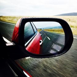 Reflection of car on side-view mirror