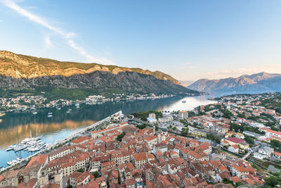 High angle view of lake by buildings against sky