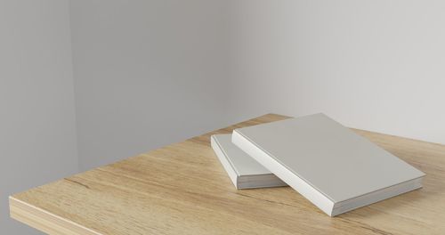 High angle view of books on table against wall