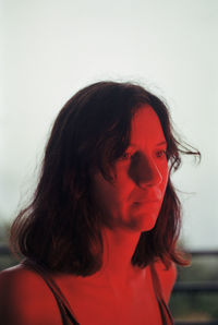 Portrait of young woman against white background