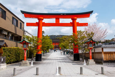 Red temple outside building against sky