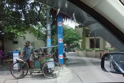 People riding bicycle on road in city