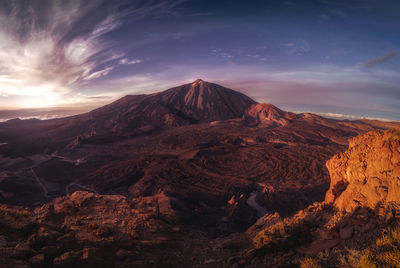 View of volcanic landscape against cloudy sky