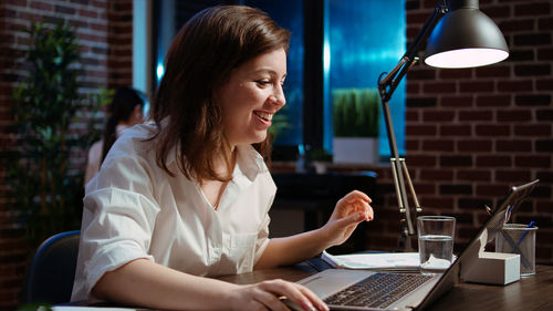 Young woman using laptop at table