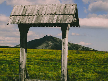 Built structure on field against sky