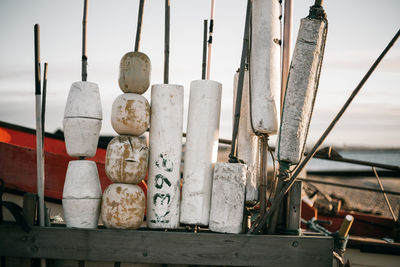Close-up of buoys at beach against sky