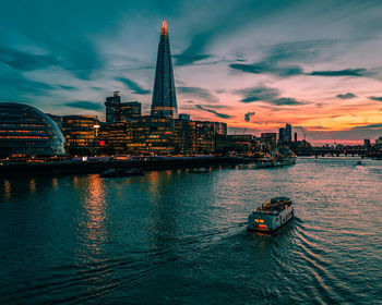 View of river and buildings against sky