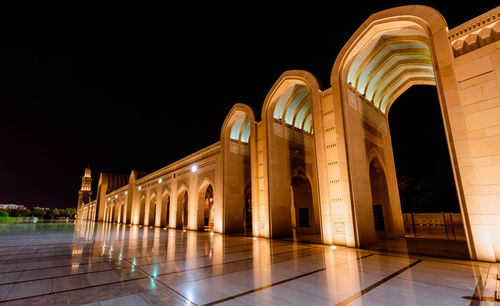 Low angle view of illuminated building against sky at night