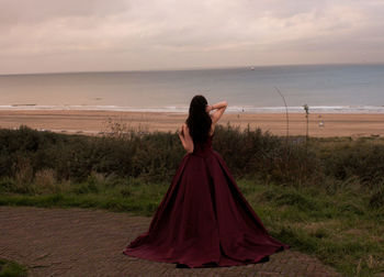 Rear view of woman standing on field