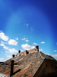 Low angle view of house roof against sky