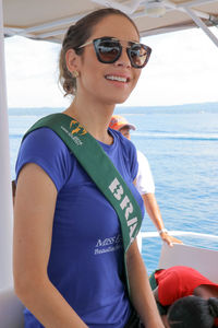 Portrait of smiling young woman in sunglasses