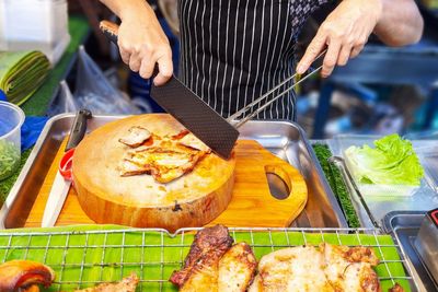 Cropped hand of person preparing food