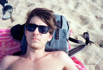 Portrait of shirtless man wearing sunglasses