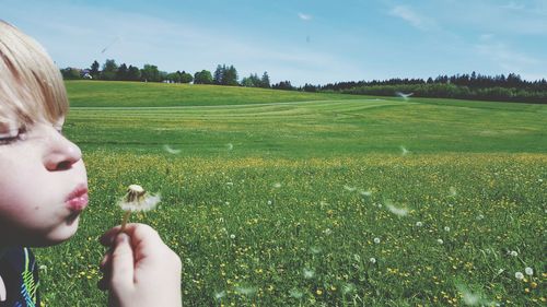 Cropped image of boy on grassy field