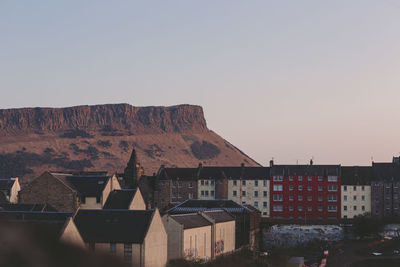 Buildings in city against clear sky