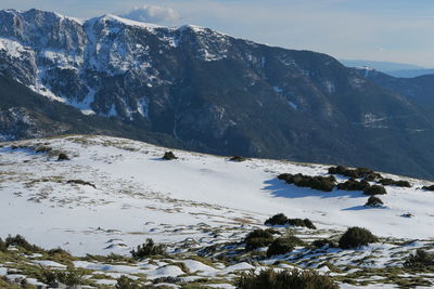 Scenic view of snowcapped mountains against sky