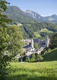 Scenic view of field and mountains against sky