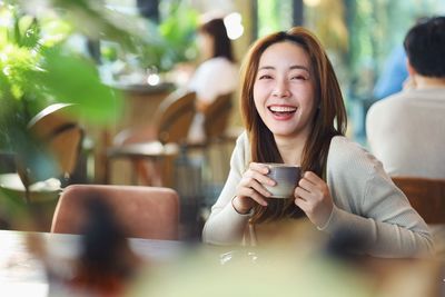 Portrait of young woman using mobile phone