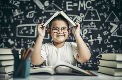 Portrait of boy reading book