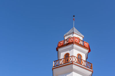 Low angle view of clock tower against clear blue sky