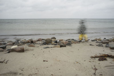 Rocks on beach against sky