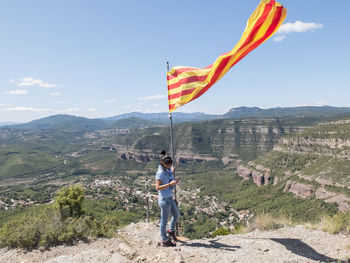 Rear view of man standing on mountain