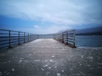 Pier over sea against sky