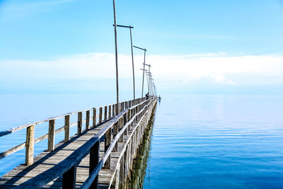 Pier over sea against sky