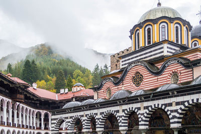 Courtyard of the rila monastery in front of foggy mountains in bulgaria