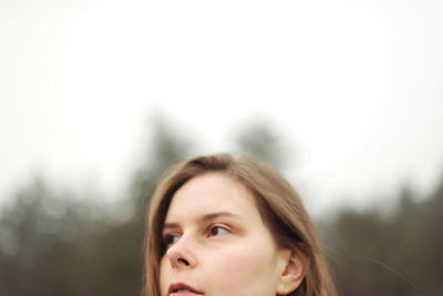 Portrait of young woman looking up