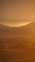 Scenic view of landscape against sky during sunset