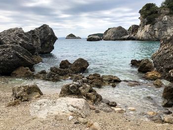 Rocks on beach against sky