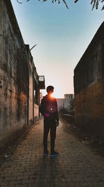 Rear view of man walking on street in city