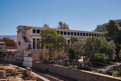 Buildings in city against clear sky