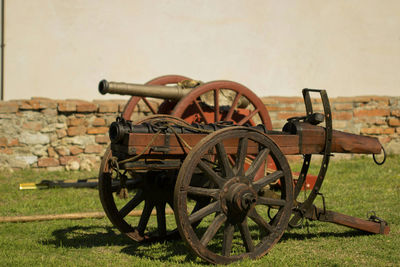 Close-up of old machinery on field