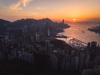 High angle view of buildings in city during sunset