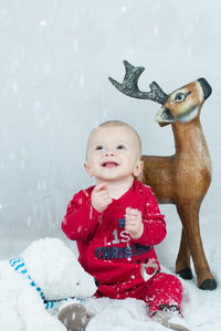 Happy girl with red and son in winter