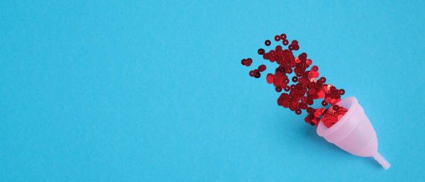 High angle view of red chili pepper against blue background