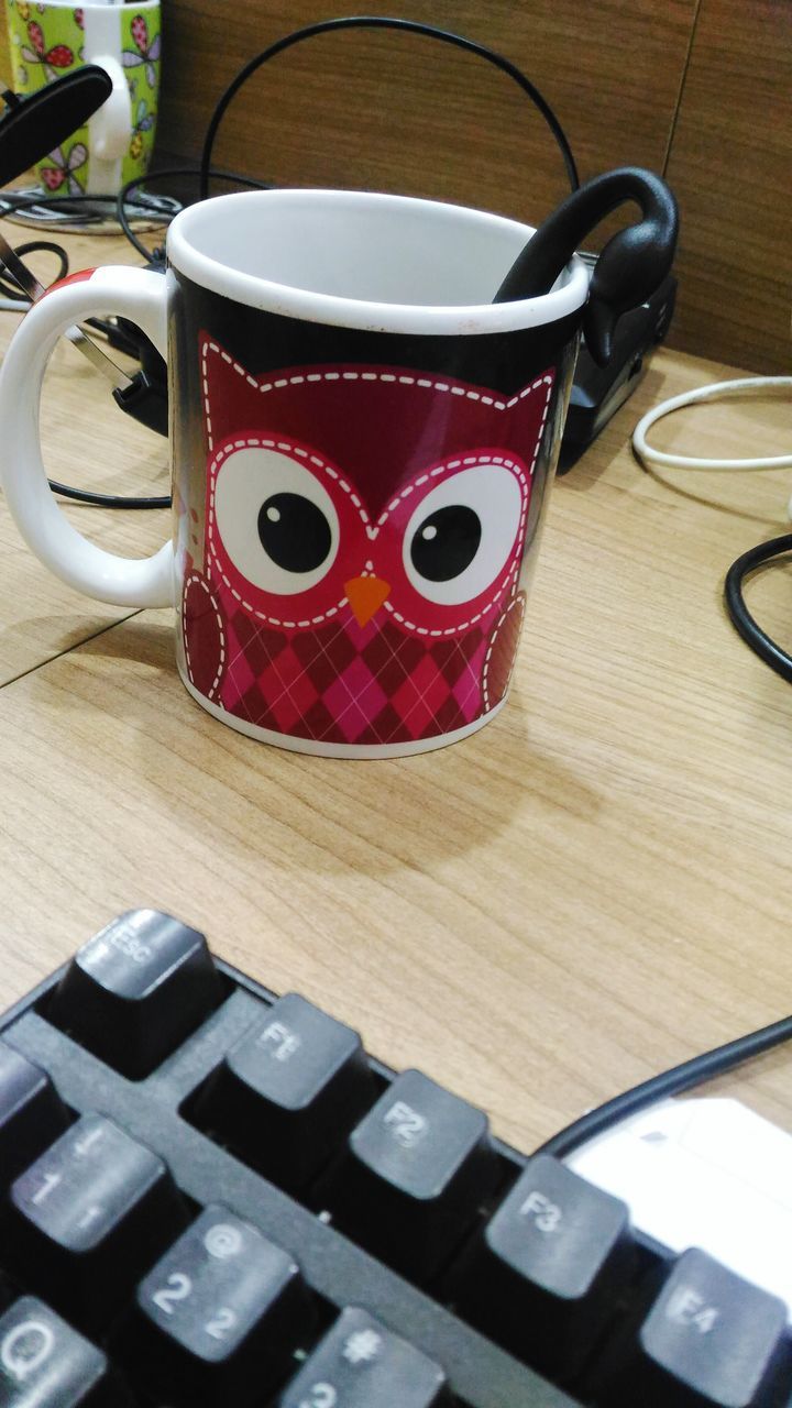 COFFEE CUP ON TABLE