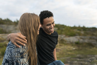 Smiling young couple embracing in nature